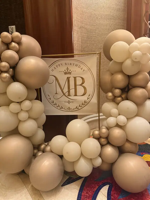 Champagne and gold organic balloon cluster with a custom sign