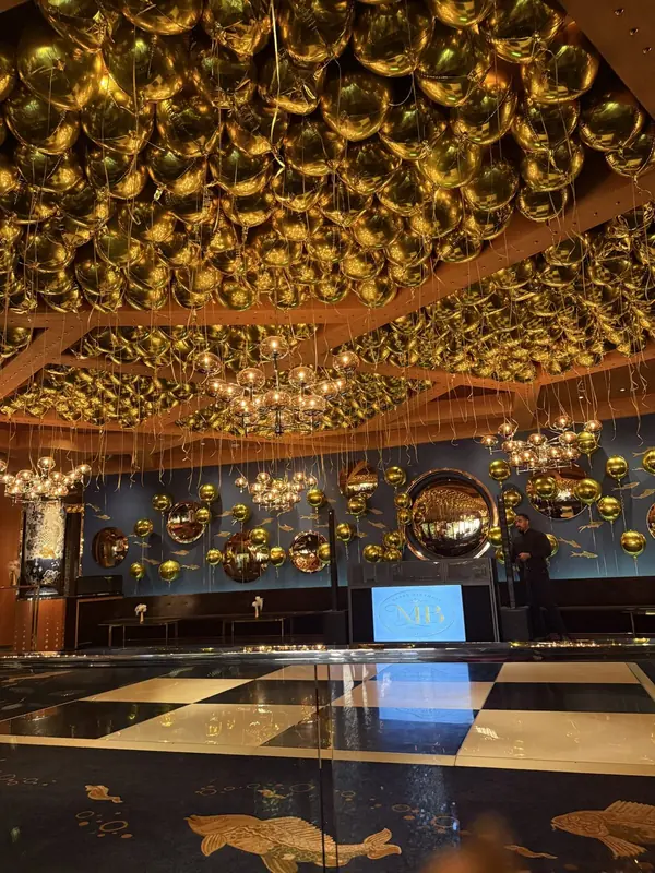 Gold balloon ceiling over a ballroom dance floor